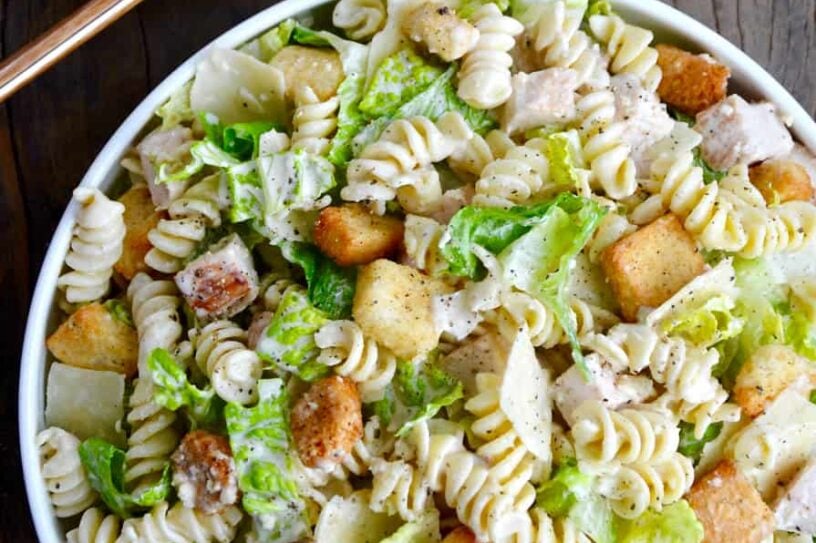 A bowl containing the best Chicken Caesar Pasta Salad.