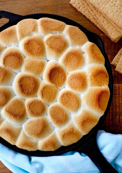 A cast-iron skillet containing toasted marshmallows